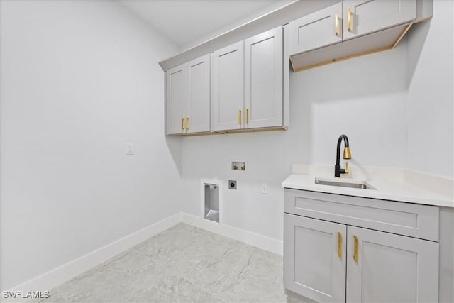 clothes washing area with cabinets, hookup for a washing machine, sink, and electric dryer hookup