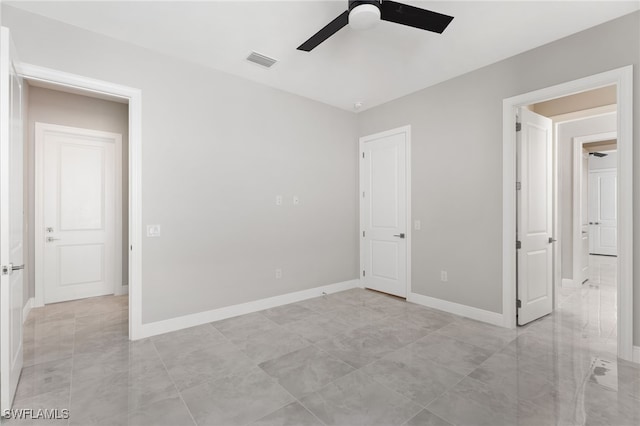 unfurnished bedroom featuring ceiling fan