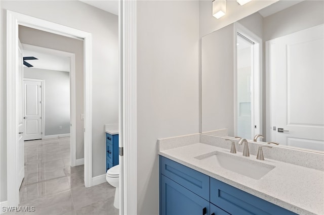 bathroom with vanity, tile patterned flooring, and toilet