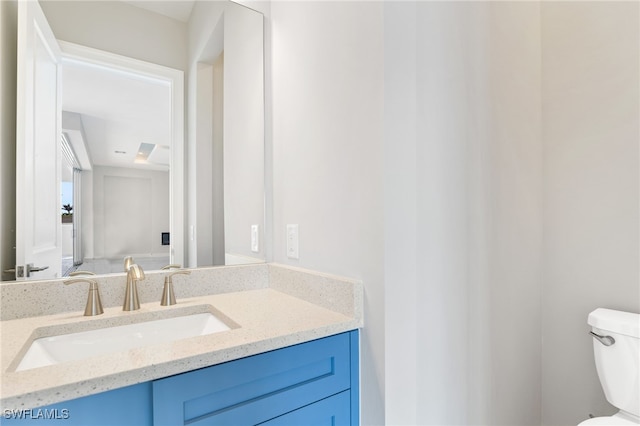 bathroom featuring vanity and toilet