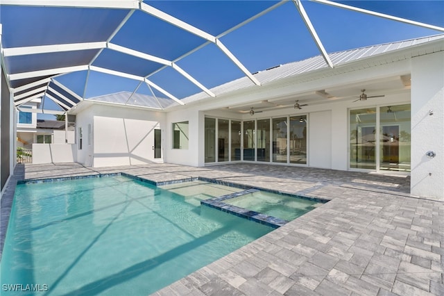 view of swimming pool featuring an in ground hot tub, ceiling fan, glass enclosure, and a patio area