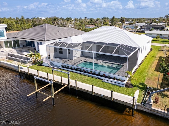 exterior space featuring a patio, a water view, a swimming pool with hot tub, and a lanai