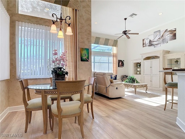 dining area featuring visible vents, light wood-style floors, ceiling fan, baseboards, and wallpapered walls