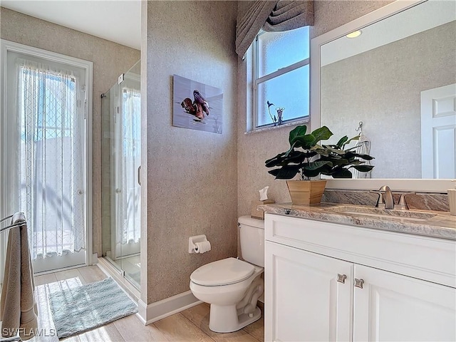 bathroom featuring plenty of natural light, a shower stall, and toilet