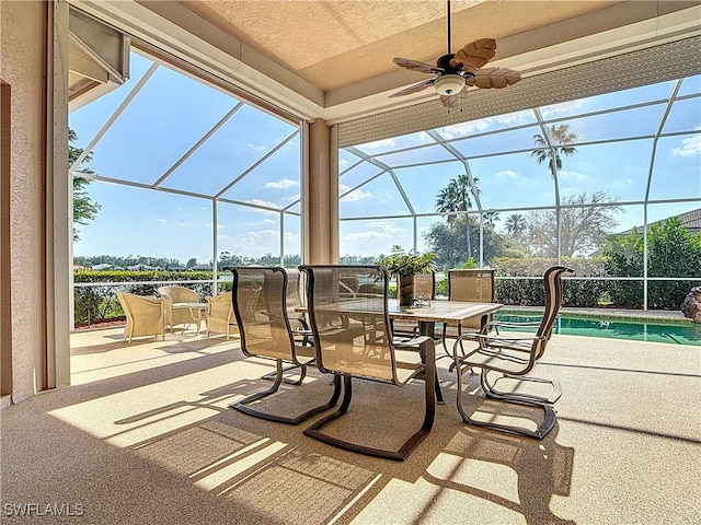 view of patio featuring glass enclosure, ceiling fan, and an outdoor pool