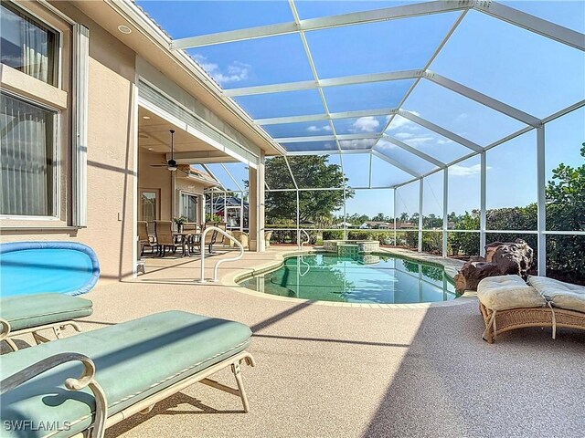 view of pool featuring a lanai, a pool with connected hot tub, a ceiling fan, and a patio