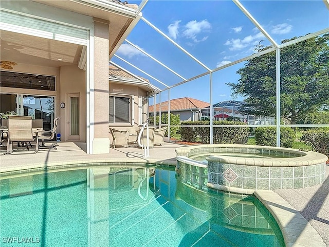 view of swimming pool with glass enclosure, a patio area, and a pool with connected hot tub