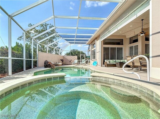 view of swimming pool with a fenced in pool, ceiling fan, an in ground hot tub, a patio area, and an outdoor living space