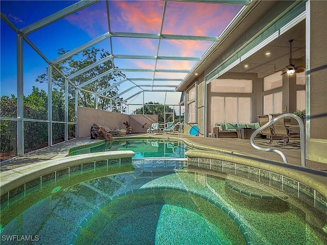 view of pool with a fenced in pool, a lanai, a patio area, and an in ground hot tub