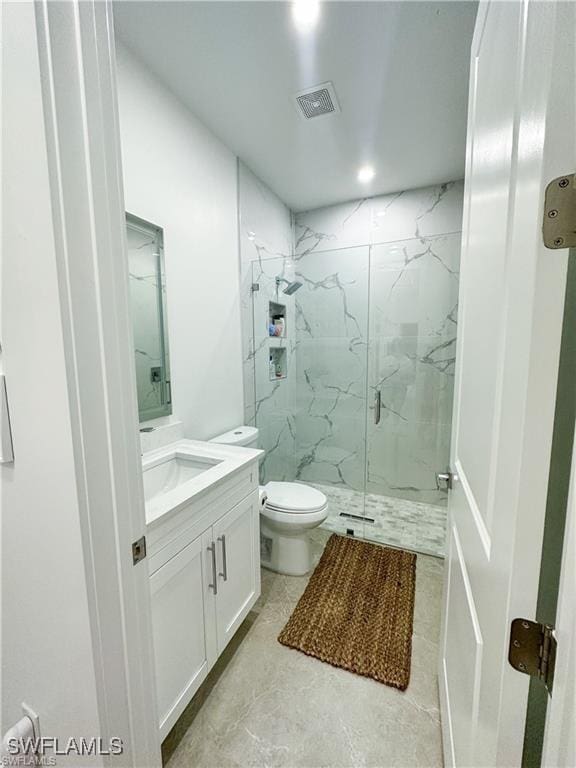 bathroom featuring vanity, toilet, and walk in shower