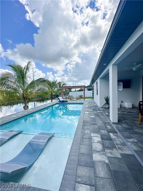 view of swimming pool featuring a pergola and a patio area