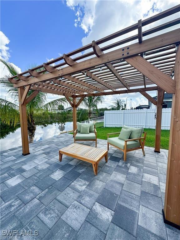 view of patio featuring a water view and a pergola