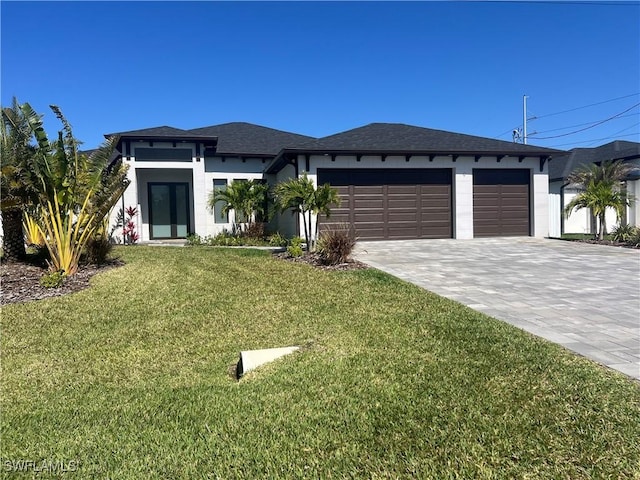 view of front of house featuring a garage and a front lawn