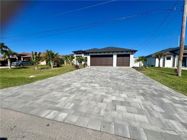 view of front of house featuring a garage and a front yard