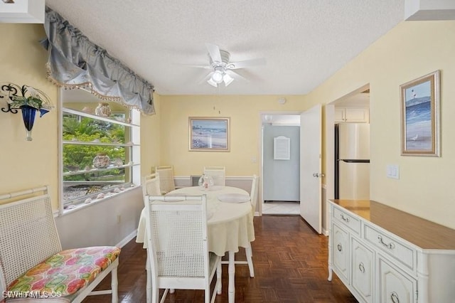 2228 Poinciana Dr, Naples, FL 34105 - dining space featuring a textured ceiling, ceiling fan, and baseboards