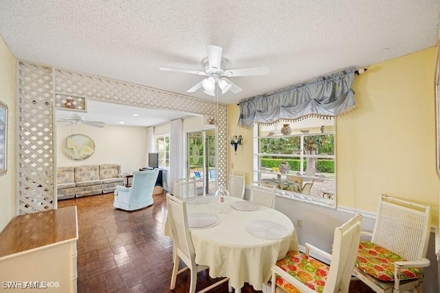 2228 Poinciana Dr, Naples, FL 34105 - dining room featuring a textured ceiling, ceiling fan, and baseboards