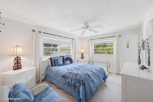 2228 Poinciana Dr, Naples, FL 34105 - bedroom featuring a textured ceiling, ceiling fan, and light colored carpet