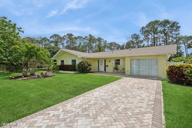 2228 Poinciana Dr, Naples, FL 34105 - ranch-style house with a front lawn and stucco siding