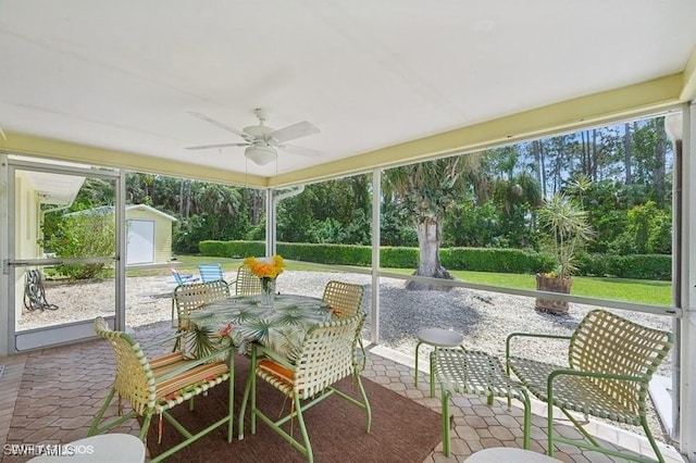 2228 Poinciana Dr, Naples, FL 34105 - view of patio featuring a ceiling fan, an outdoor structure, outdoor dining area, and a storage shed