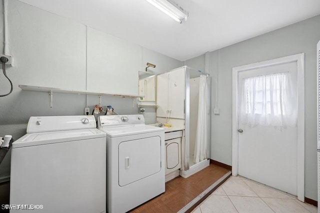 2228 Poinciana Dr, Naples, FL 34105 - clothes washing area with washing machine and dryer, cabinet space, and light tile patterned floors
