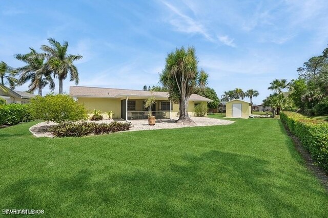 2228 Poinciana Dr, Naples, FL 34105 - rear view of house with stucco siding, an outbuilding, a yard, and a shed