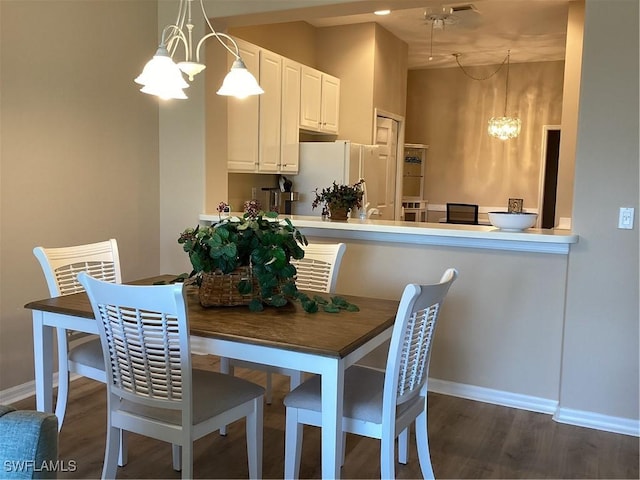 8528 Brittania Dr, Fort Myers, FL 33912 - dining area with dark wood-type flooring and a notable chandelier
