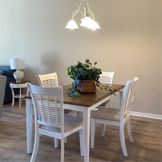 8528 Brittania Dr, Fort Myers, FL 33912 - dining space with wood-type flooring and a notable chandelier