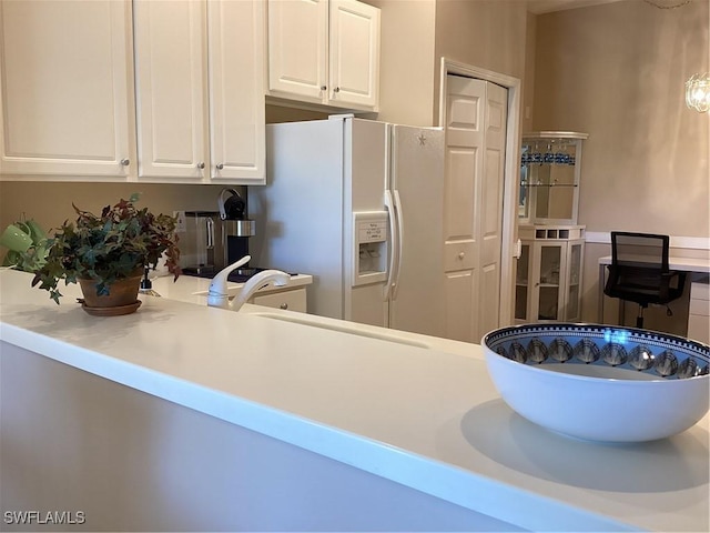 8528 Brittania Dr, Fort Myers, FL 33912 - kitchen featuring white refrigerator with ice dispenser, sink, and white cabinets