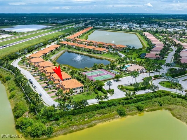 birds eye view of property with a water view and a residential view