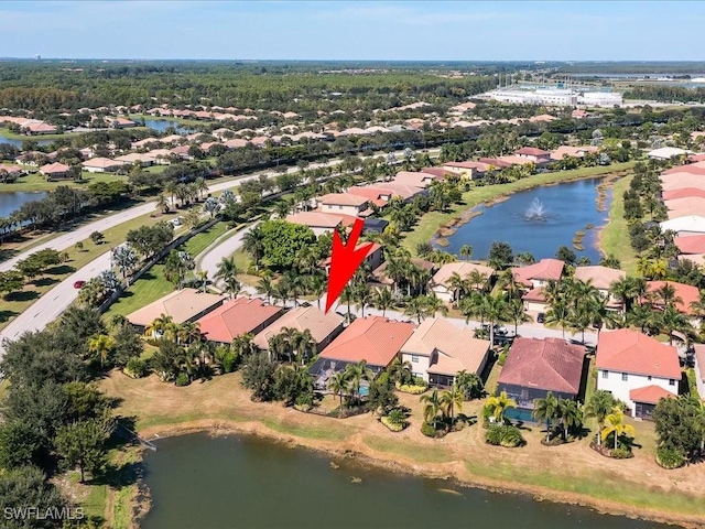 drone / aerial view featuring a residential view and a water view