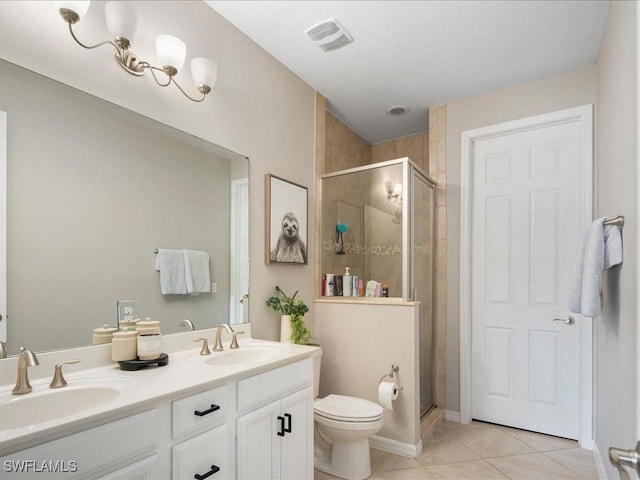 bathroom featuring toilet, a sink, visible vents, and tile patterned floors