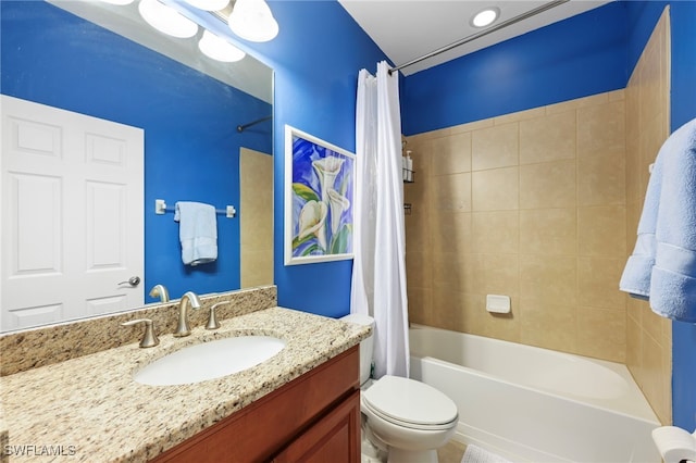 bathroom featuring shower / bath combo, vanity, and toilet