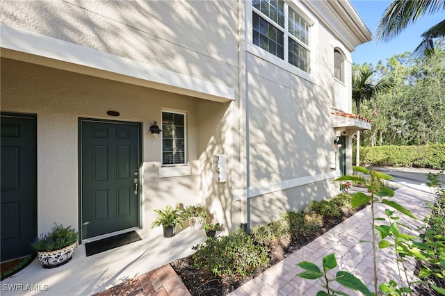 property entrance with stucco siding