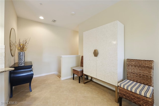 living area with light tile patterned floors, baseboards, visible vents, and recessed lighting