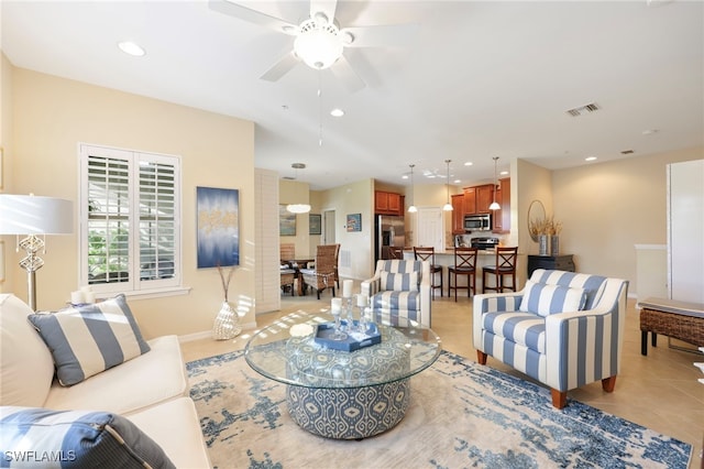living area featuring light tile patterned floors, ceiling fan, recessed lighting, visible vents, and baseboards