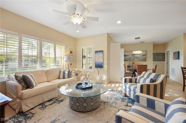 living room featuring ceiling fan, light tile patterned floors, recessed lighting, visible vents, and baseboards
