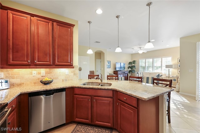 kitchen with a peninsula, a sink, dishwasher, and decorative light fixtures