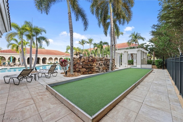 view of community featuring fence, a pool, and a pergola