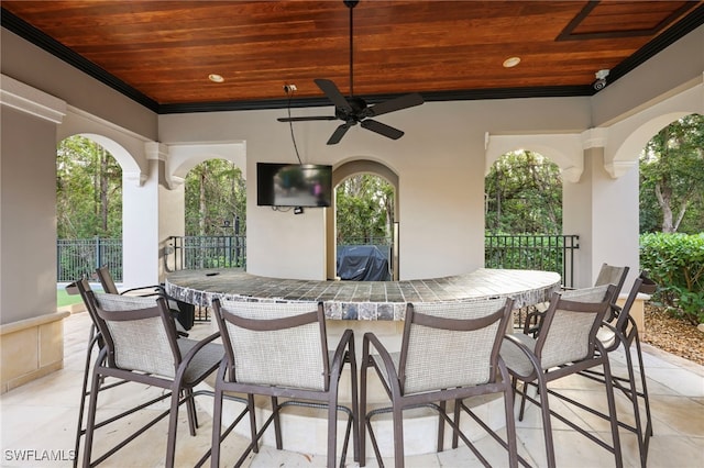 view of patio / terrace with a ceiling fan, fence, outdoor dry bar, and area for grilling