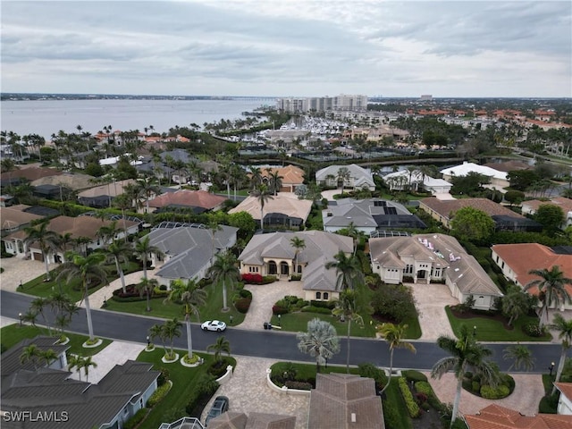 drone / aerial view featuring a residential view and a water view