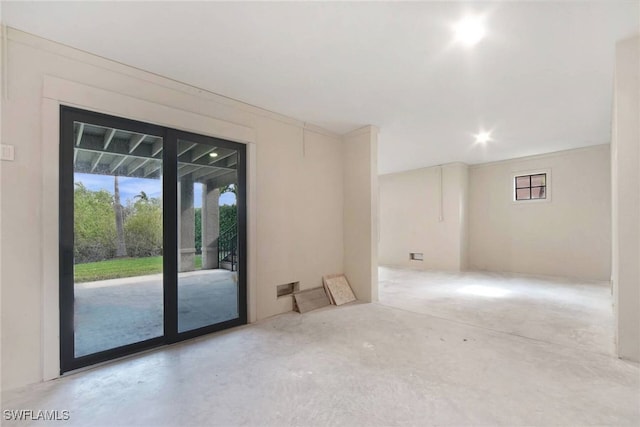 unfurnished room with plenty of natural light and concrete floors