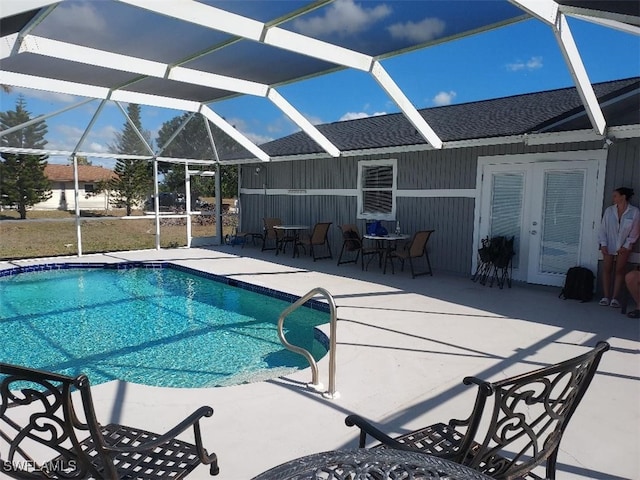 view of swimming pool featuring a lanai and a patio