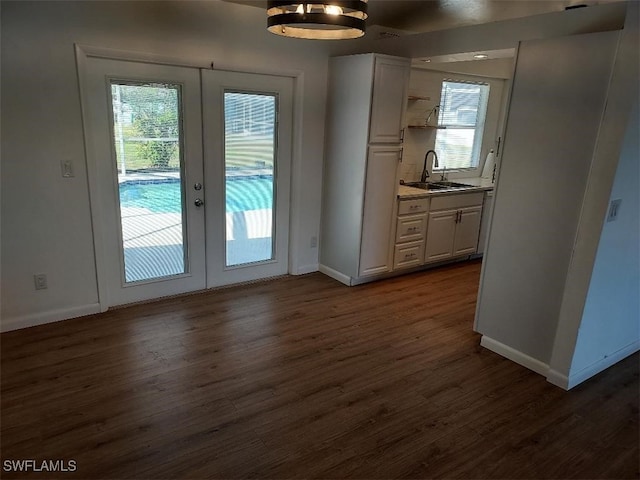 doorway to outside with sink, dark wood-type flooring, and french doors