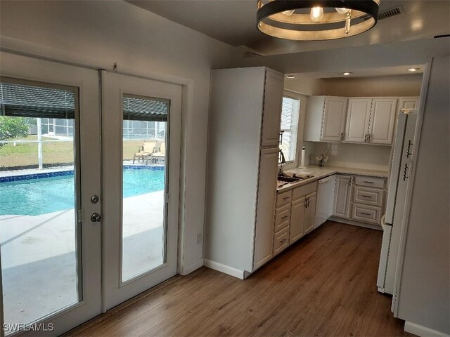 entryway featuring french doors, dark wood-type flooring, and sink