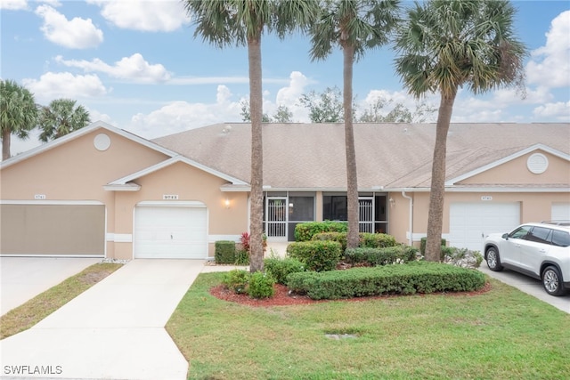 ranch-style home with a front yard and a garage