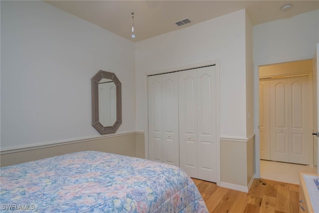 bedroom with light wood-type flooring and a closet