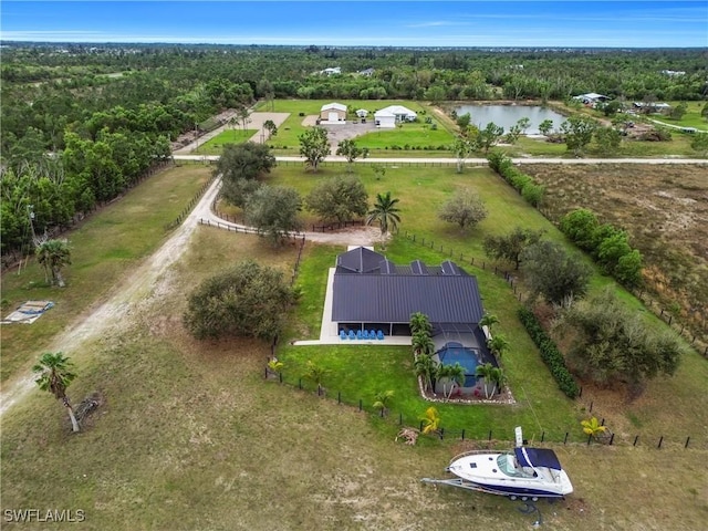 birds eye view of property with a water view and a view of trees