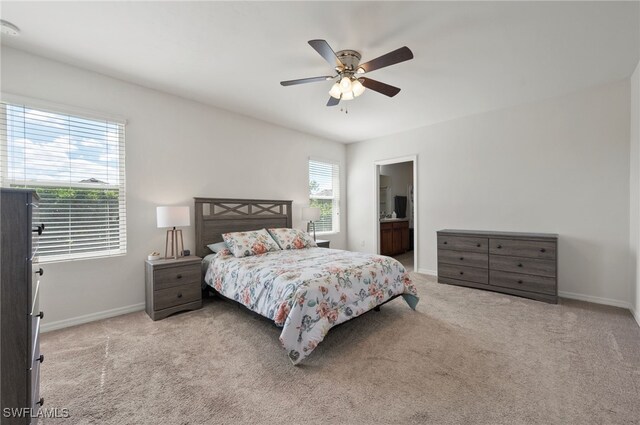 2550 Ocasa Ct, Cape Coral, FL 33909 - carpeted bedroom featuring a ceiling fan, ensuite bath, and baseboards
