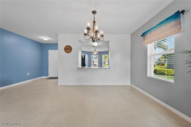 2550 Ocasa Ct, Cape Coral, FL 33909 - unfurnished room featuring light tile patterned floors, baseboards, and ceiling fan with notable chandelier