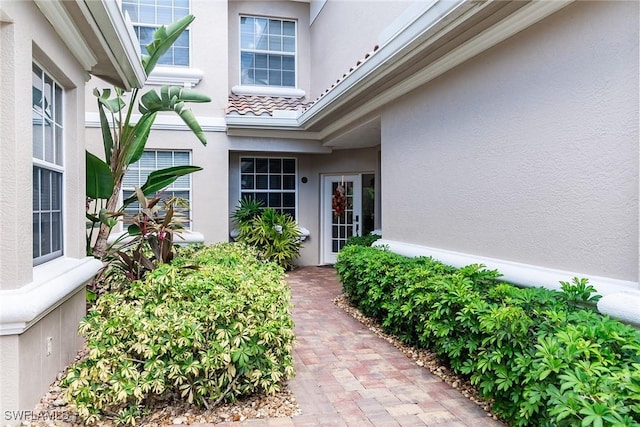 property entrance with stucco siding